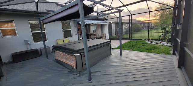 wooden deck featuring a lanai, a hot tub, and fence