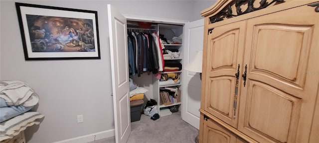 spacious closet featuring light colored carpet