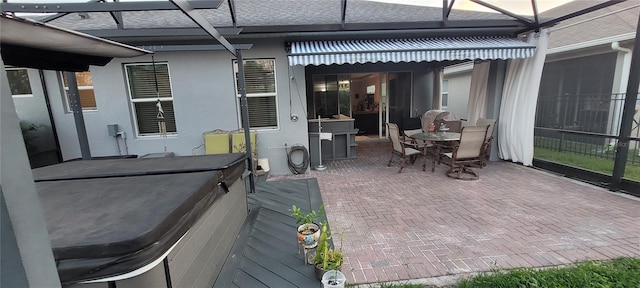 view of patio / terrace featuring outdoor dining space and a lanai