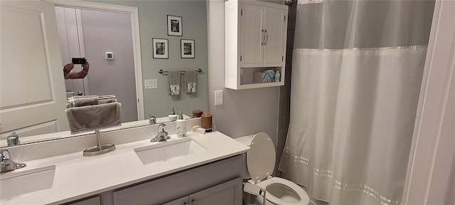 full bathroom featuring a sink, toilet, and double vanity