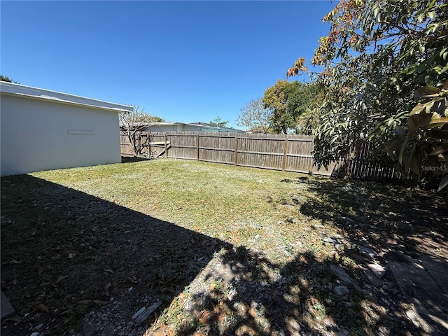 view of yard with a fenced backyard