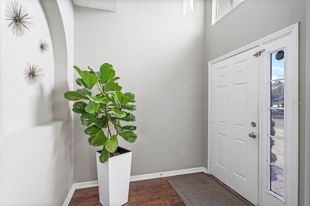 entryway featuring dark wood finished floors and baseboards