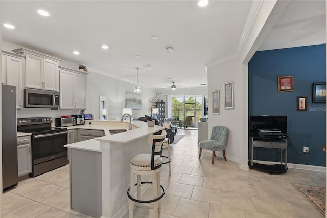 kitchen featuring open floor plan, appliances with stainless steel finishes, crown molding, and a peninsula