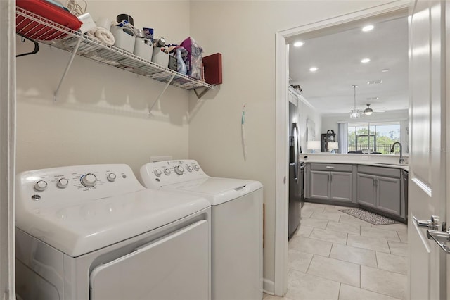 laundry room featuring visible vents, light tile patterned floors, laundry area, independent washer and dryer, and a sink