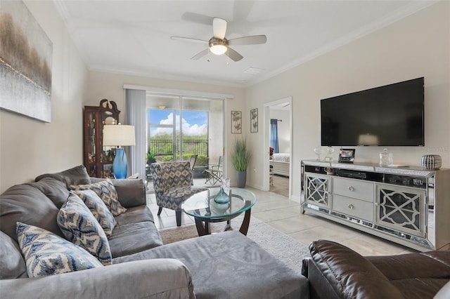 living area with light tile patterned floors, baseboards, ceiling fan, and ornamental molding