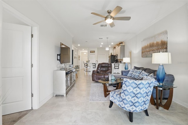 living area with crown molding, recessed lighting, baseboards, and ceiling fan