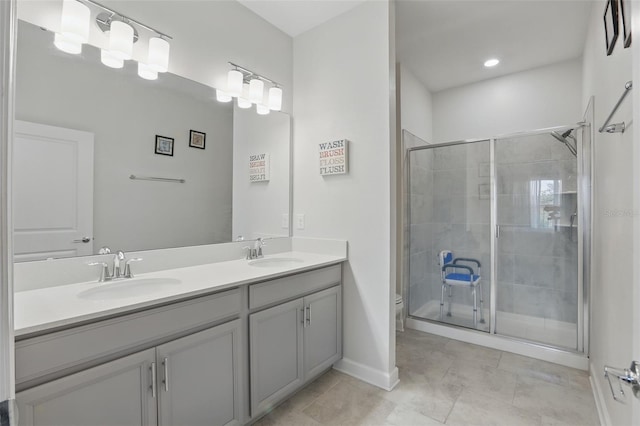 full bath featuring a sink, toilet, a stall shower, and double vanity