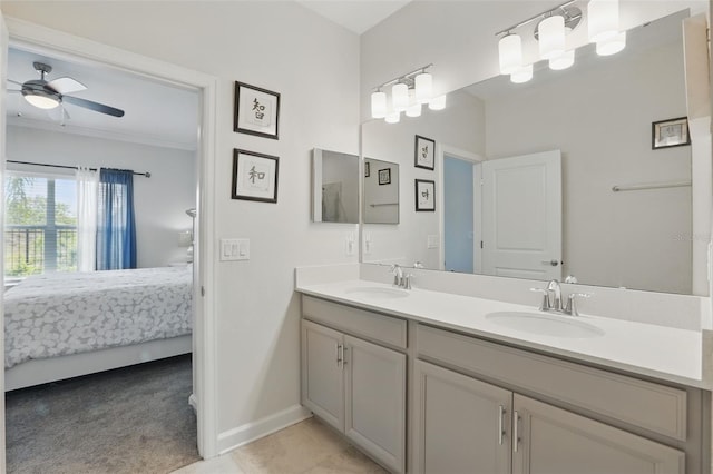 ensuite bathroom with ceiling fan, double vanity, connected bathroom, and a sink