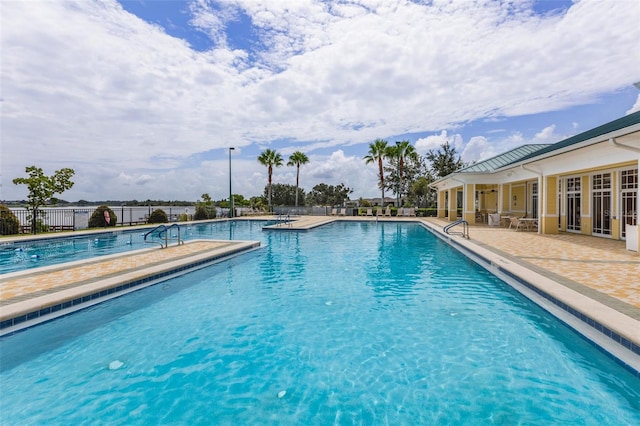 pool featuring a patio area, french doors, and fence