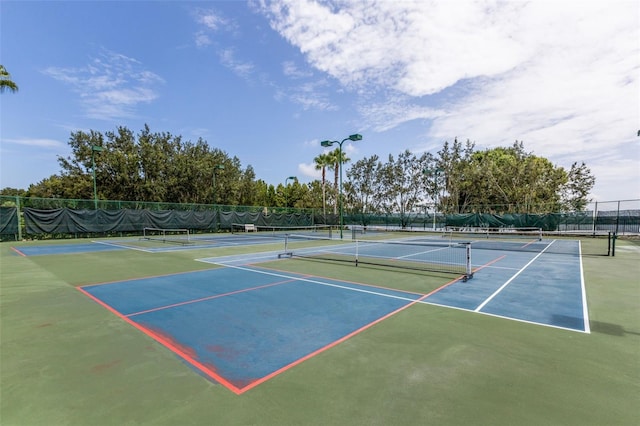 view of sport court featuring fence