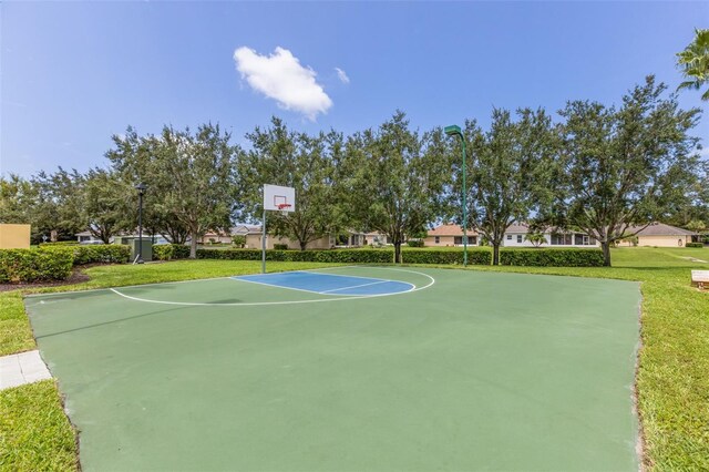 view of basketball court with a yard and community basketball court