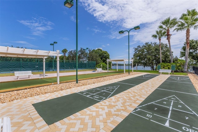 surrounding community featuring shuffleboard and fence