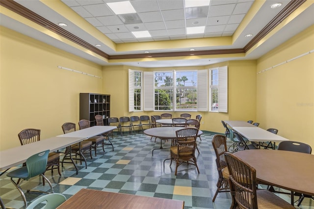 rec room featuring a raised ceiling and ornamental molding