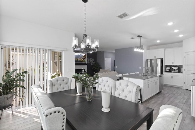 dining room featuring a notable chandelier, recessed lighting, light wood-style floors, and visible vents