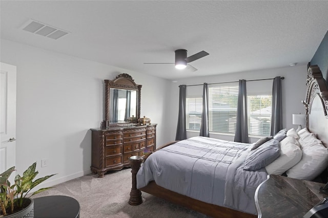 bedroom with visible vents, baseboards, a ceiling fan, and carpet flooring