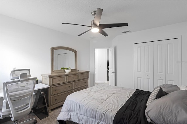 bedroom with visible vents, carpet floors, a closet, and ceiling fan