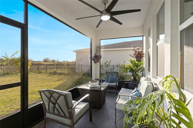 sunroom featuring a ceiling fan