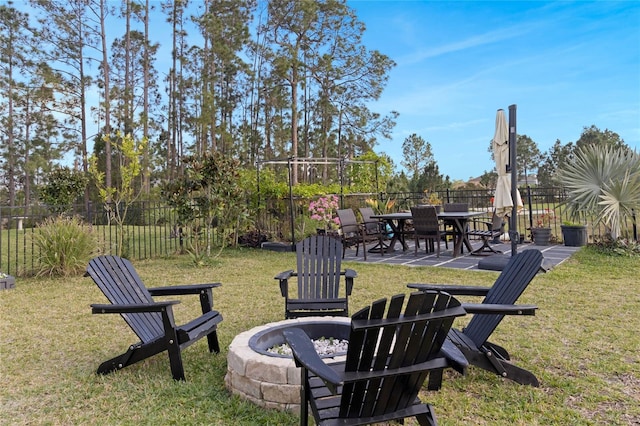 view of yard with an outdoor fire pit, a patio, and fence