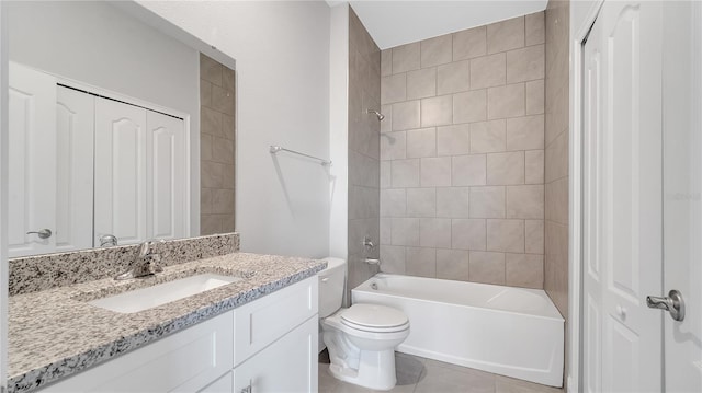 bathroom with toilet, tile patterned floors, vanity, and  shower combination