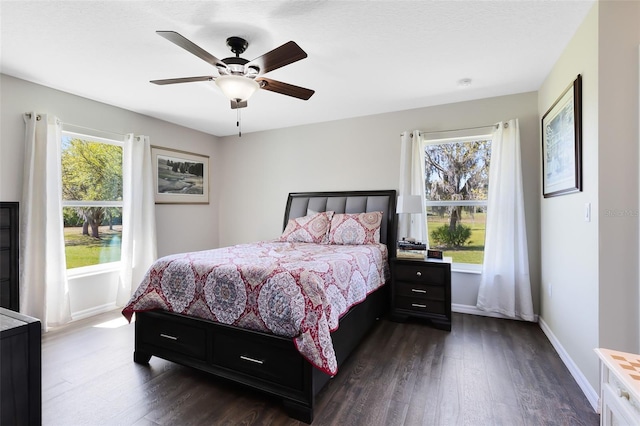 bedroom with baseboards, ceiling fan, and dark wood-style flooring