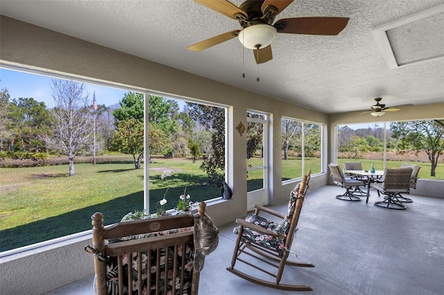 sunroom featuring ceiling fan