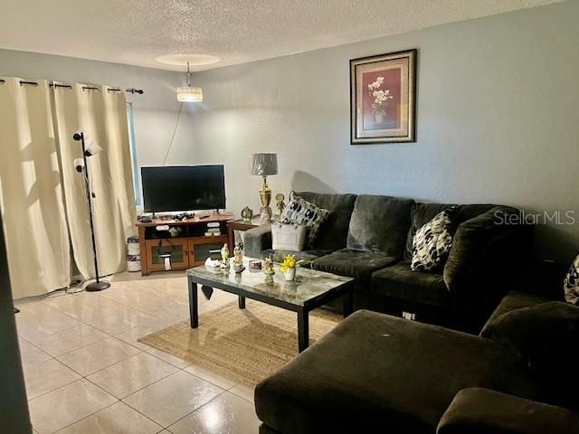 living area with tile patterned flooring and a textured ceiling