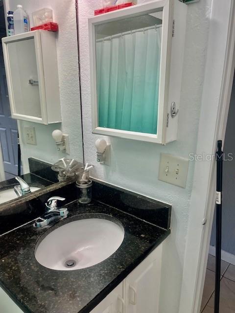 bathroom featuring tile patterned floors and vanity