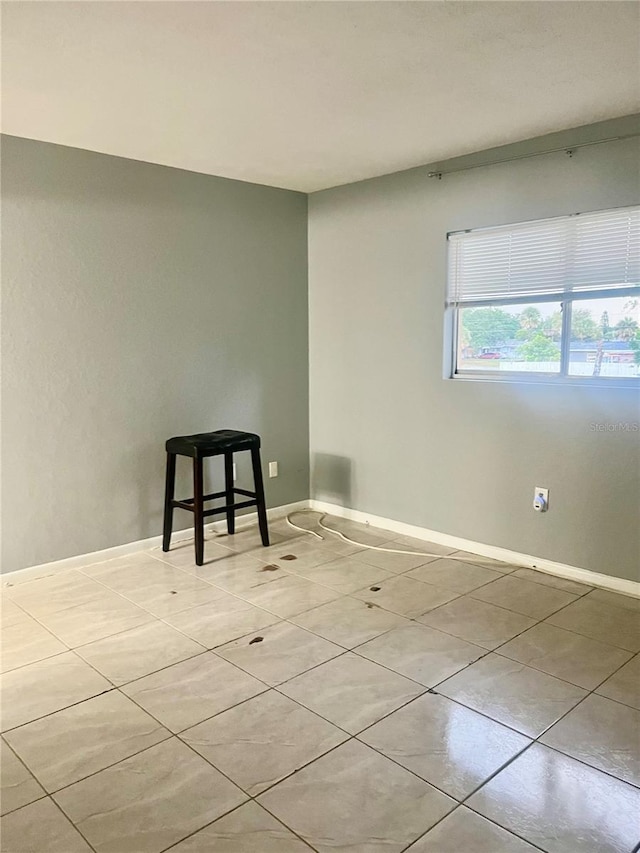 731 Wyman Ct Unit 731-A, Orlando, FL 32809 - empty room featuring light tile patterned floors and baseboards