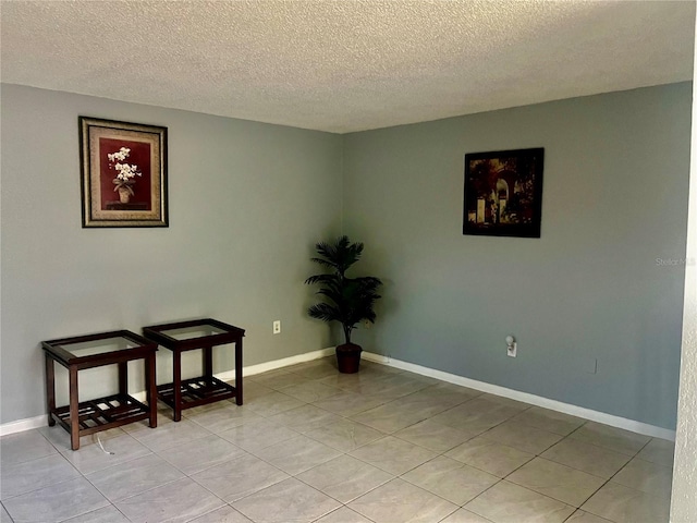 731 Wyman Ct Unit 731-A, Orlando, FL 32809 - empty room with a textured ceiling, light tile patterned floors, and baseboards