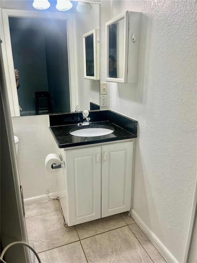 731 Wyman Ct Unit 731-A, Orlando, FL 32809 - bathroom featuring a textured wall, vanity, and tile patterned flooring