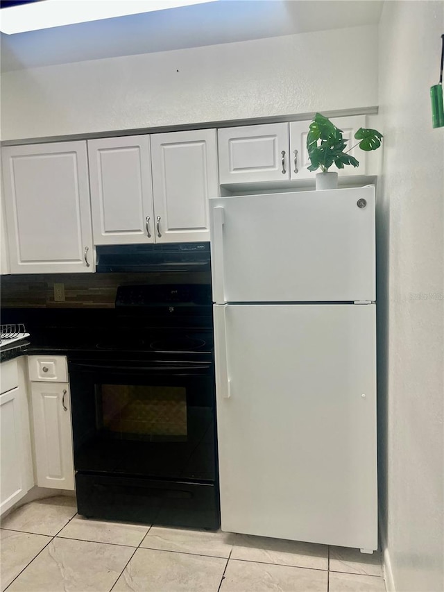 731 Wyman Ct Unit 731-A, Orlando, FL 32809 - kitchen featuring freestanding refrigerator, black range with electric stovetop, under cabinet range hood, and white cabinetry