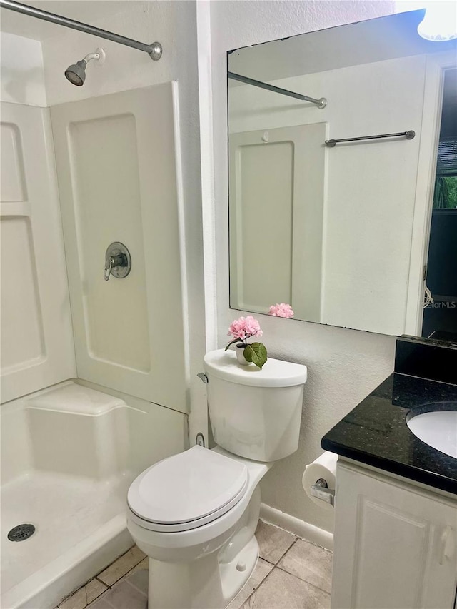 731 Wyman Ct Unit 731-A, Orlando, FL 32809 - bathroom featuring tile patterned flooring, a stall shower, vanity, and toilet