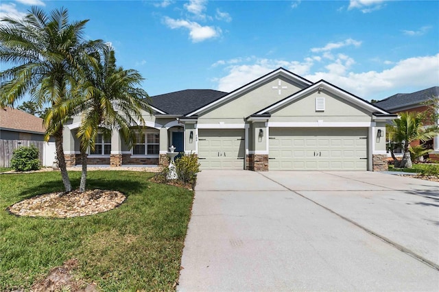 craftsman house with concrete driveway, a front yard, stucco siding, a garage, and stone siding