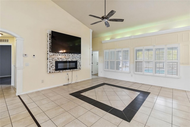 unfurnished living room with visible vents, lofted ceiling, a ceiling fan, tile patterned flooring, and baseboards