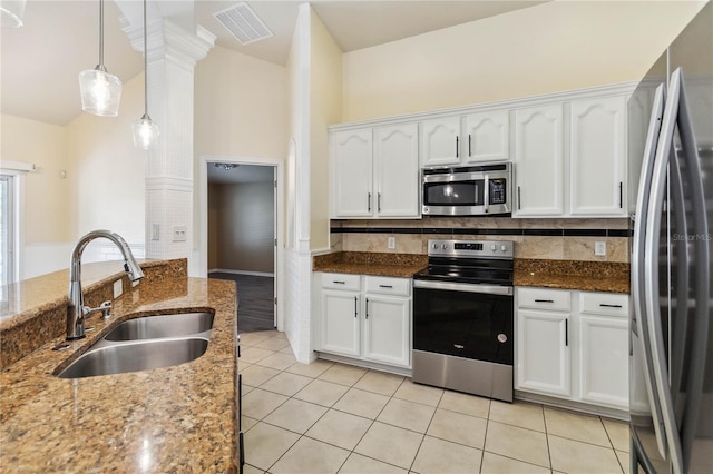 kitchen with visible vents, light tile patterned floors, stainless steel appliances, white cabinetry, and a sink