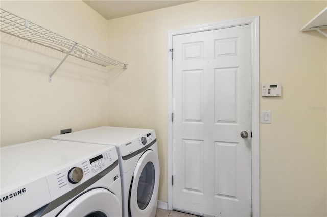 washroom featuring laundry area and washing machine and clothes dryer