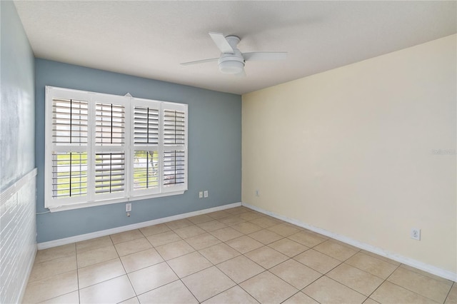 unfurnished room featuring light tile patterned floors, baseboards, and ceiling fan