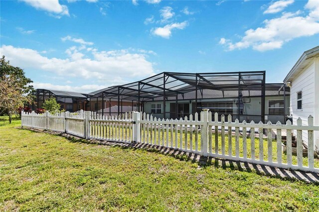 view of yard featuring a lanai and a fenced front yard