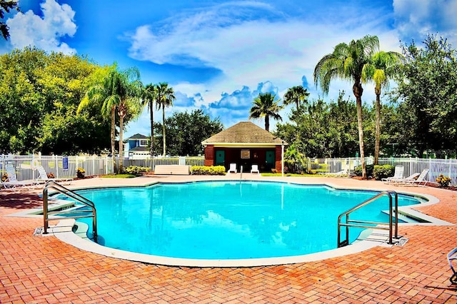 community pool featuring a patio and fence