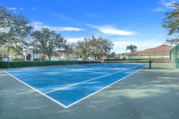 view of tennis court with fence