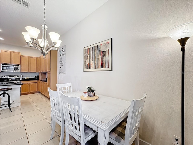 dining area with light tile patterned floors, visible vents, and a chandelier