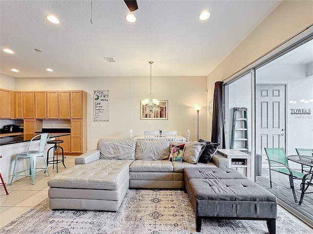 living room with visible vents, light tile patterned flooring, recessed lighting, a textured ceiling, and a chandelier