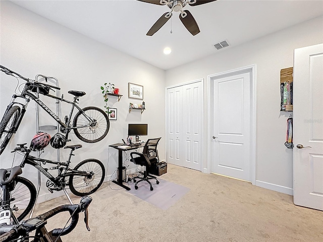 office featuring visible vents, baseboards, light colored carpet, and ceiling fan