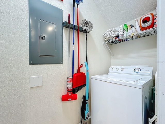 laundry area featuring washer / dryer, electric panel, a textured wall, and laundry area