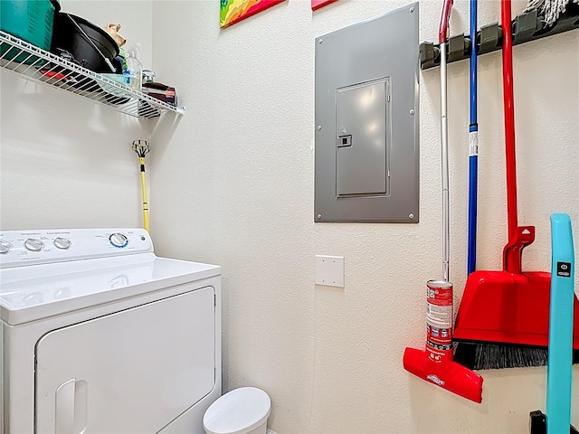 washroom featuring electric panel, washer / dryer, laundry area, and a textured wall