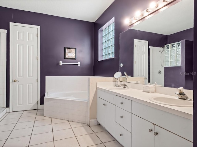 bathroom with tile patterned floors, a bath, a shower stall, and a sink