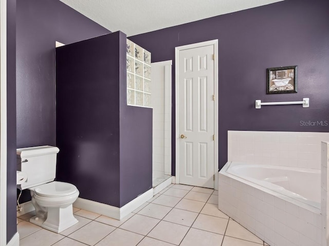 bathroom featuring a walk in shower, baseboards, toilet, a garden tub, and tile patterned floors