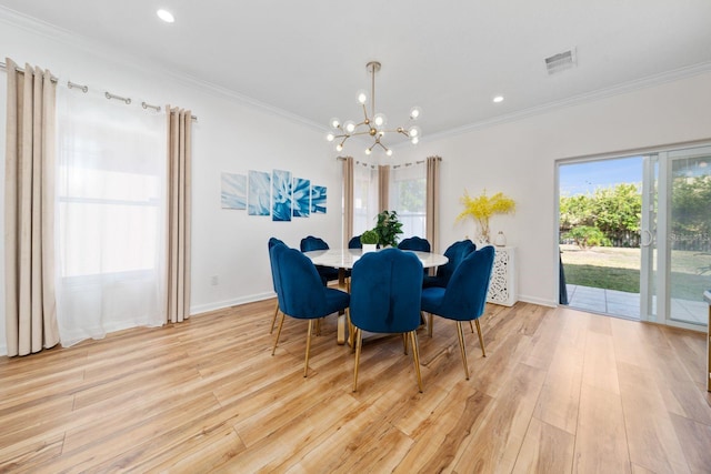 dining room featuring light wood-style floors, plenty of natural light, a notable chandelier, and ornamental molding