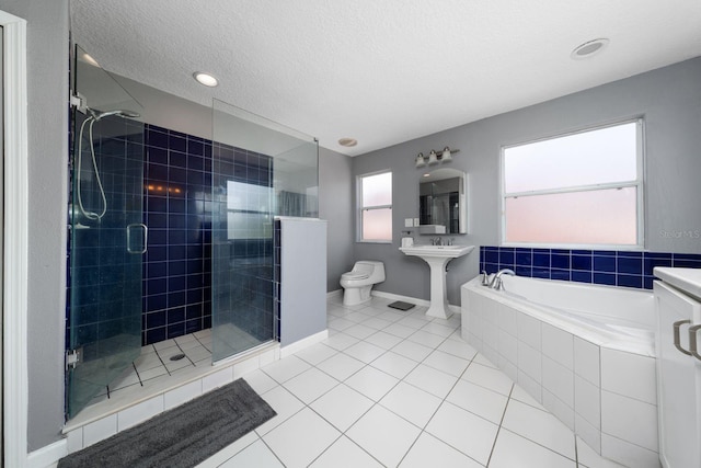 full bathroom featuring a stall shower, a textured ceiling, a garden tub, toilet, and tile patterned floors