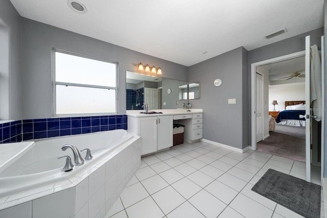 ensuite bathroom with tile patterned flooring, visible vents, connected bathroom, a walk in shower, and a garden tub